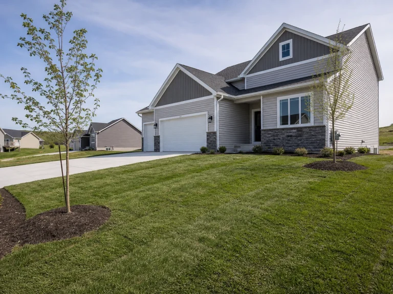 New construction landscaping with young sod and plantings in Hudson, Iowa