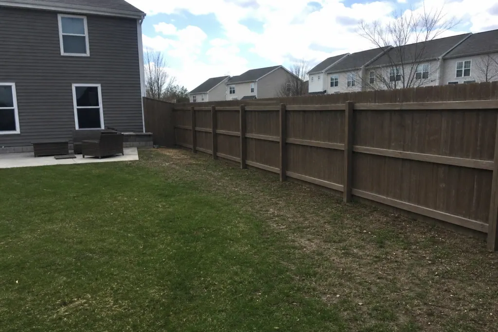 Plain grass along privacy fence before landscape bed installation