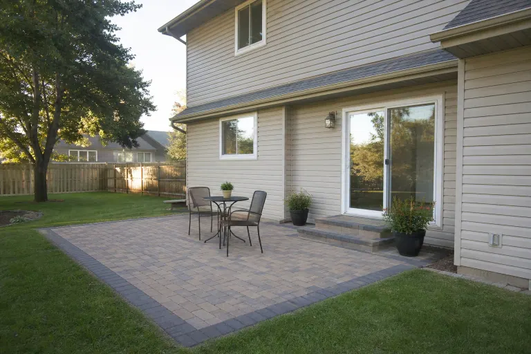 Completed paver patio with fire pit and seating area