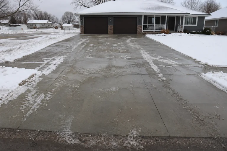 Cleared residential driveway and sidewalk after snow removal