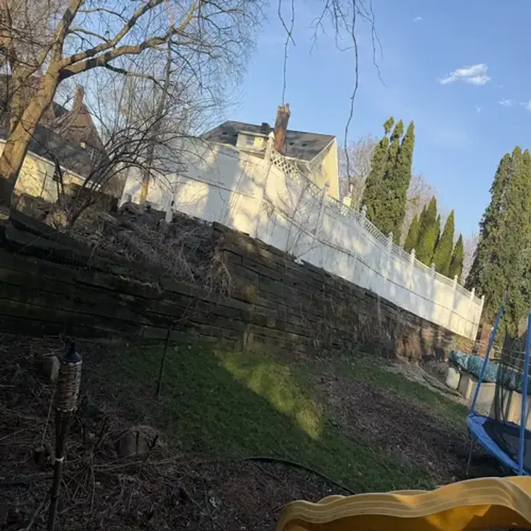 Aged wooden retaining wall before replacement