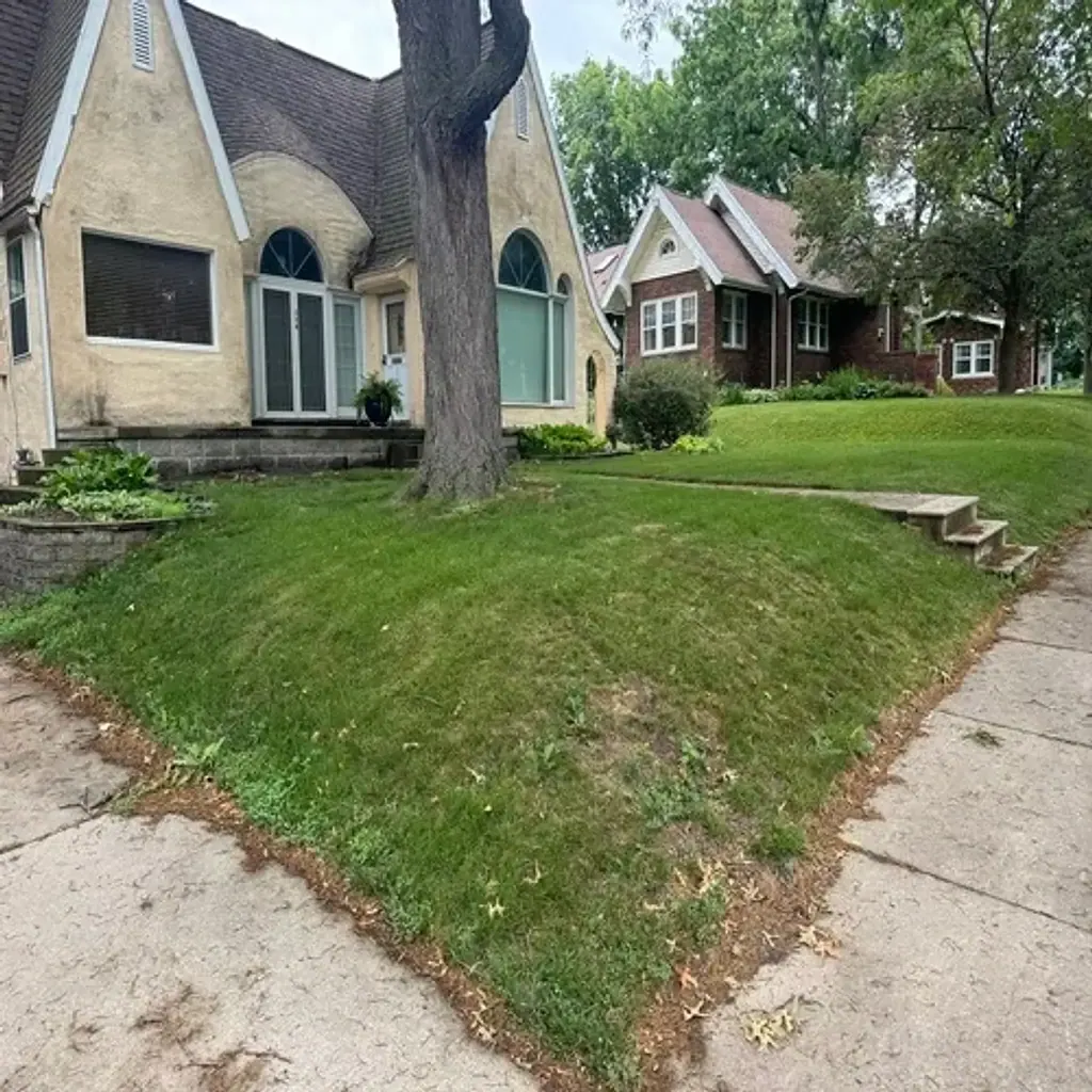 Sloped front yard before retaining wall installation