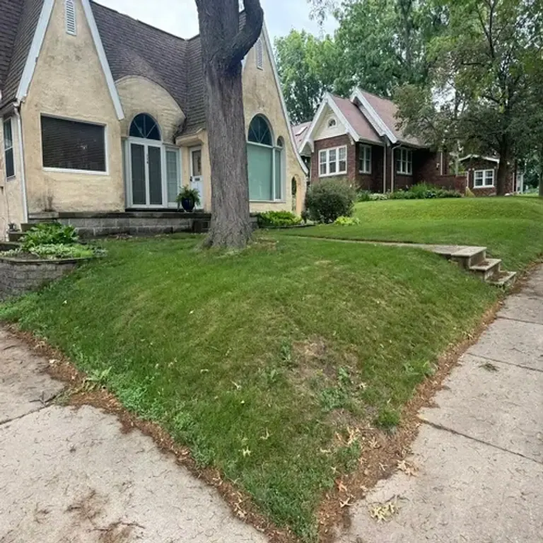 Sloped front yard before retaining wall installation