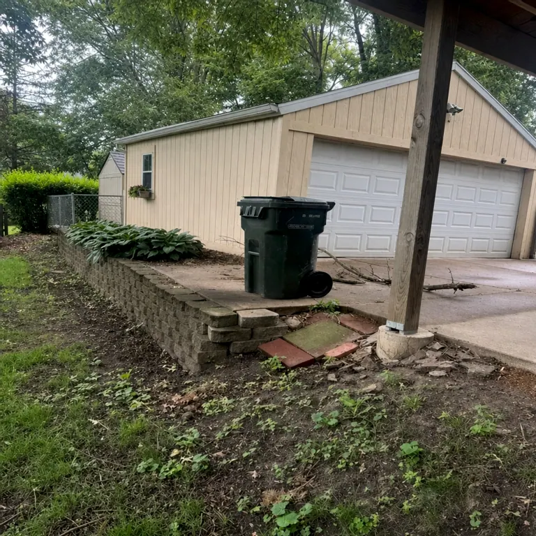 Damaged retaining wall before garage-side rebuild
