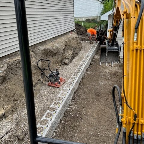Retaining wall under construction in Cedar Falls, Iowa, highlighting the progress and craftsmanship during installation.