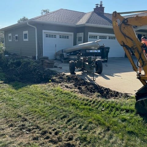Before photo of a retaining wall site in Cedar Falls, Iowa, showing the landscape prior to construction.