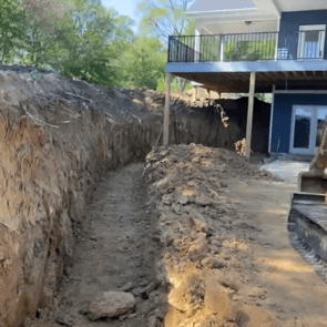 Before photo of a retaining wall site in Cedar Falls, Iowa, showing the area prior to construction.