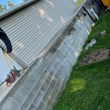 Before photo of a retaining wall site in Cedar Falls, Iowa, highlighting the area before installation.