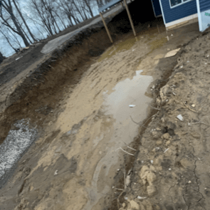 Before photo of a retaining wall site in Cedar Falls, Iowa, showing the landscape before construction.